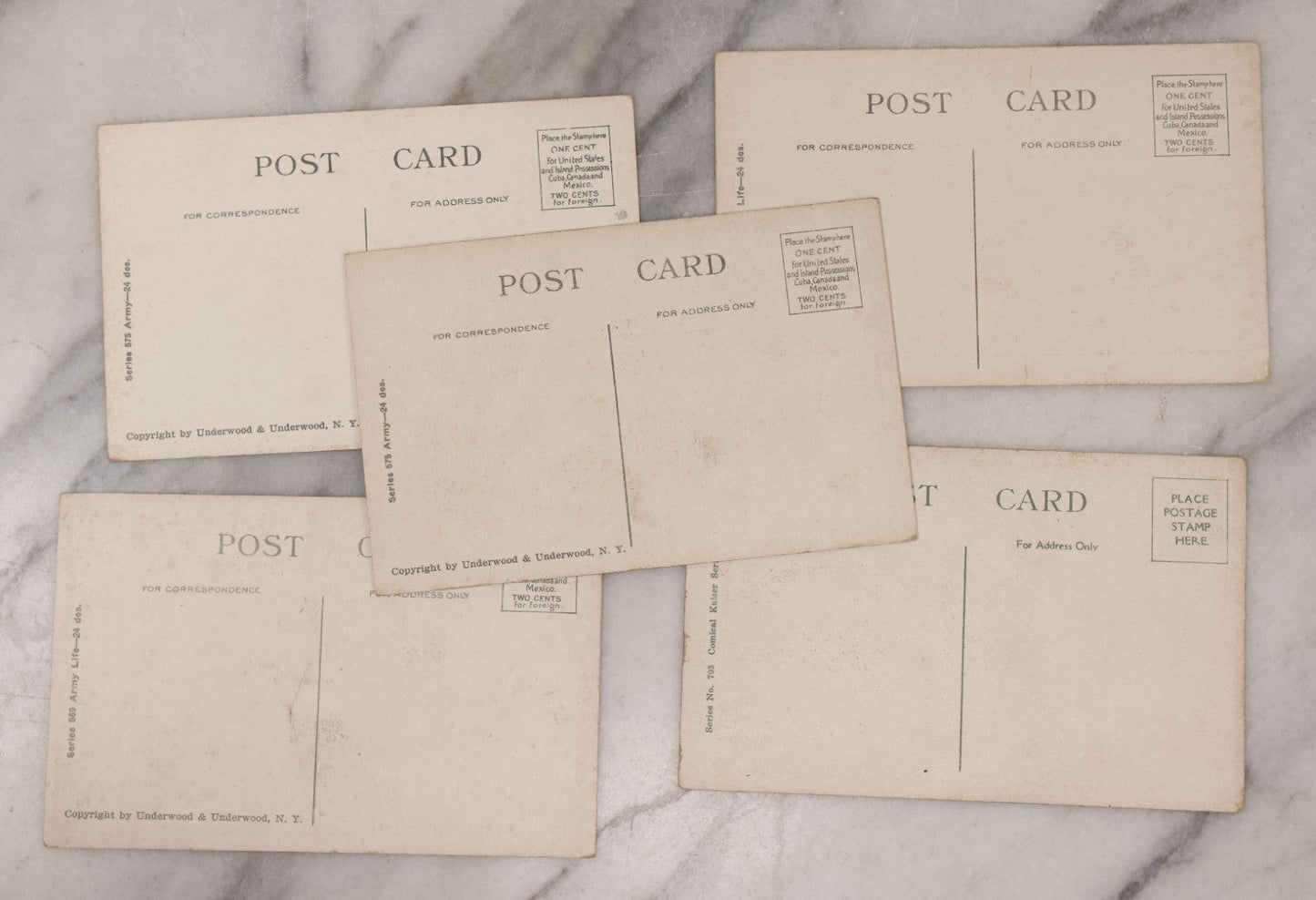 Lot 082 - Grouping Of Five Antique World War One Era Postcards Documenting The War Including Comic Illustration, Uncle Sam Placing Kaiser In Garbage, Soldier Shaving, Tank In Action, Motorcycle Ambulance, And Rifle Practice
