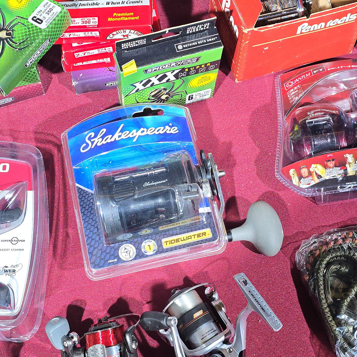 Grouping of Modern Fishing Reels, Line, and Tackle including Shimano Caenan 100, Shakespeare Tidewater, Quantum, and Penn Reels