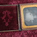 Lot 131 - Antique Ambrotype Of Young Baby Girl With Fluffy Object Next To Her - Possibly Cat - In Full Leatherette Union Case, Repaired Hinge, 1/6th Plate