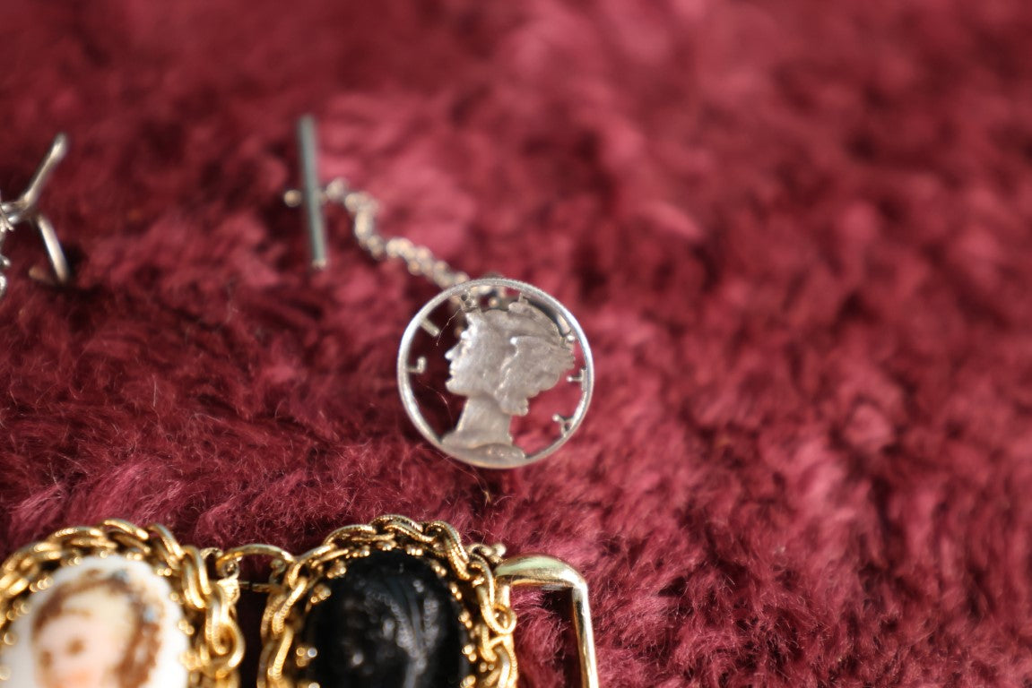 Lot 053 - Eleven Piece Mixed Jewelry Grouping Including Sterling Silver Thai Cufflinks, Tiny Pin Marked 10K, Mercury Dime Jewelry, And More
