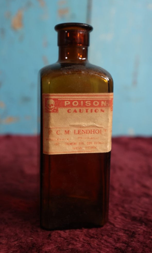 Lot 132 - Antique Amber Glass Bottle With Poison Label From F.C.M Lendholt, Skull And Crossbones, Label May Have Been Added Later