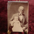 Lot 104 - Tintype - Old Balding Man, Grandfather, Holding Unhappy Looking Baby