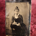 Lot 109 - Tintype - Pretty Young Woman With Up-Do, Leaning On Arms On Chair Arm, Wearing Bracelets, Cuffs
