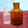 Lot 155 - Two Piece Poison Bottle Lot, Amber Bottle With Raised Letters, Small Clear Bottle