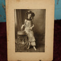Lot 068 - Antique Boarded Photo Of Pretty Woman With Elaborate Costume, Drumming, Photographed By Charles "Chas" Betz Of Louisville, Kentucky, "Love To Mama And Papa From Florence," Writing On Back