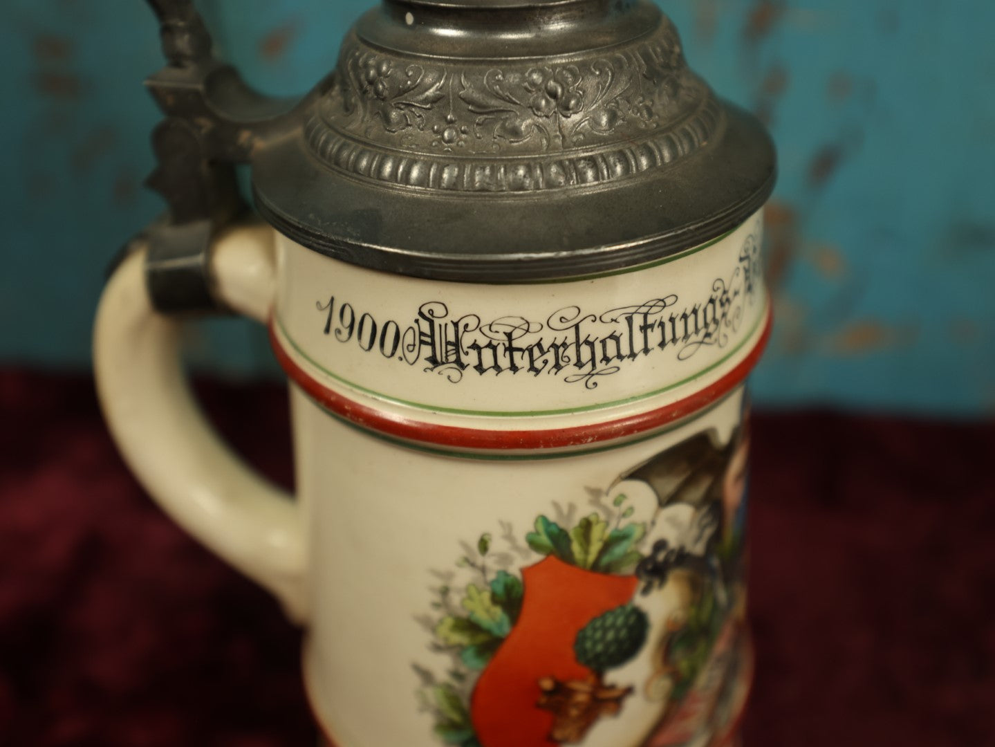 Lot 027 - Antique 1905 German Stein Having To Do With A Social Club, Featuring Winged Bat-Like Woman, Face Impaled Through Eye Ball, Augsburg Coat Of Arms, Signed Jos. (Joseph) Weber, Augsburg, With Markings