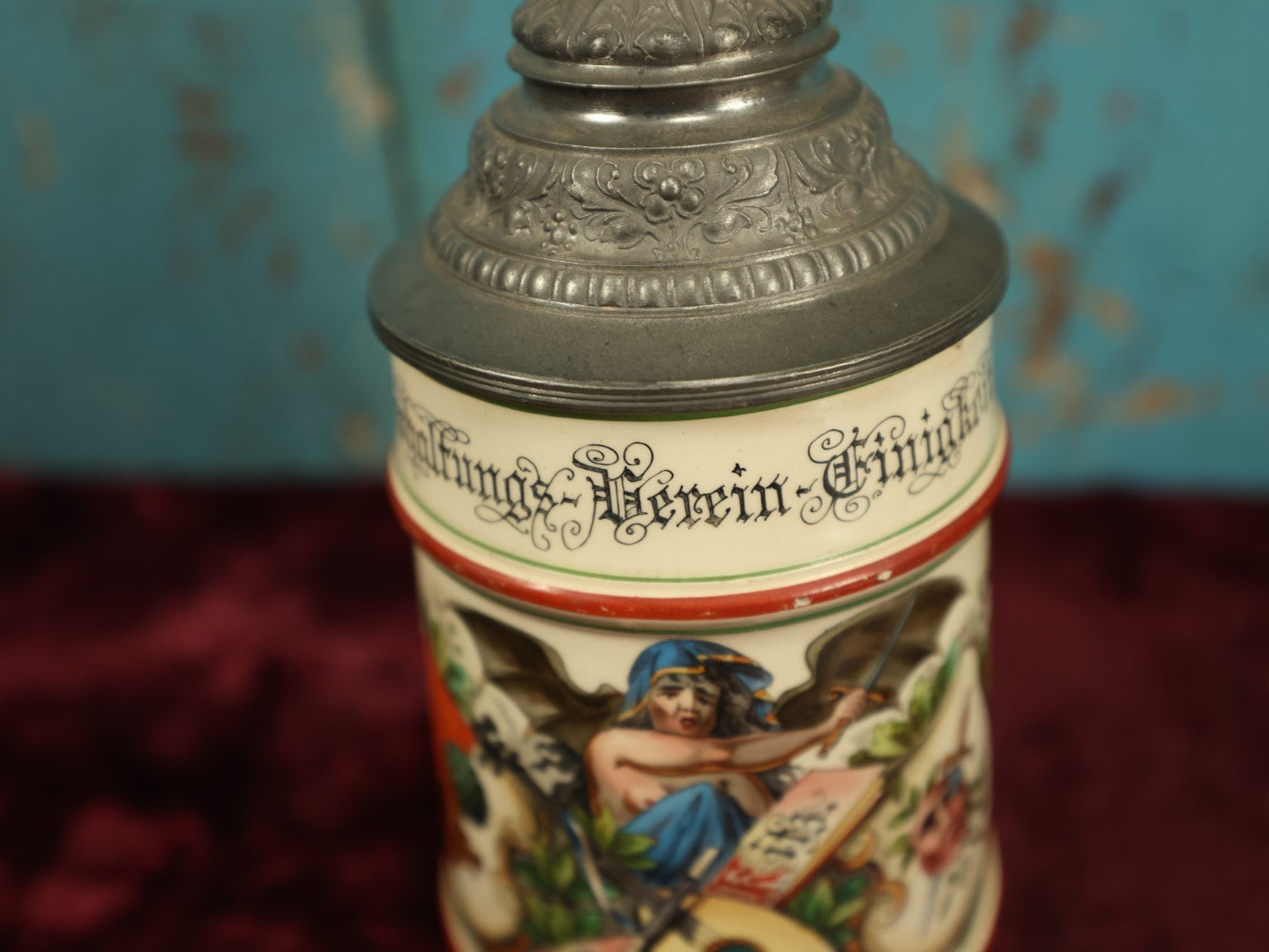 Lot 027 - Antique 1905 German Stein Having To Do With A Social Club, Featuring Winged Bat-Like Woman, Face Impaled Through Eye Ball, Augsburg Coat Of Arms, Signed Jos. (Joseph) Weber, Augsburg, With Markings