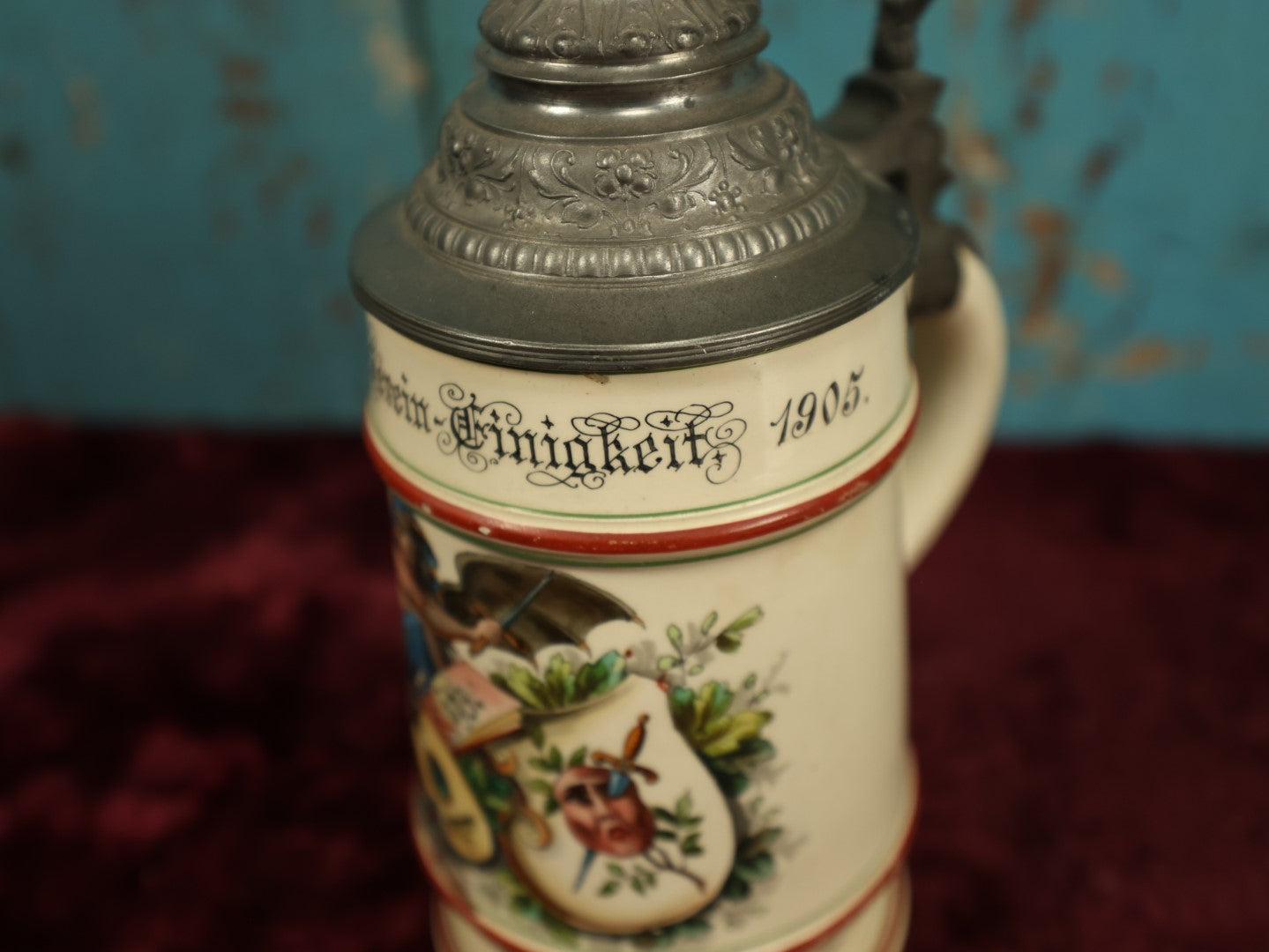 Lot 027 - Antique 1905 German Stein Having To Do With A Social Club, Featuring Winged Bat-Like Woman, Face Impaled Through Eye Ball, Augsburg Coat Of Arms, Signed Jos. (Joseph) Weber, Augsburg, With Markings