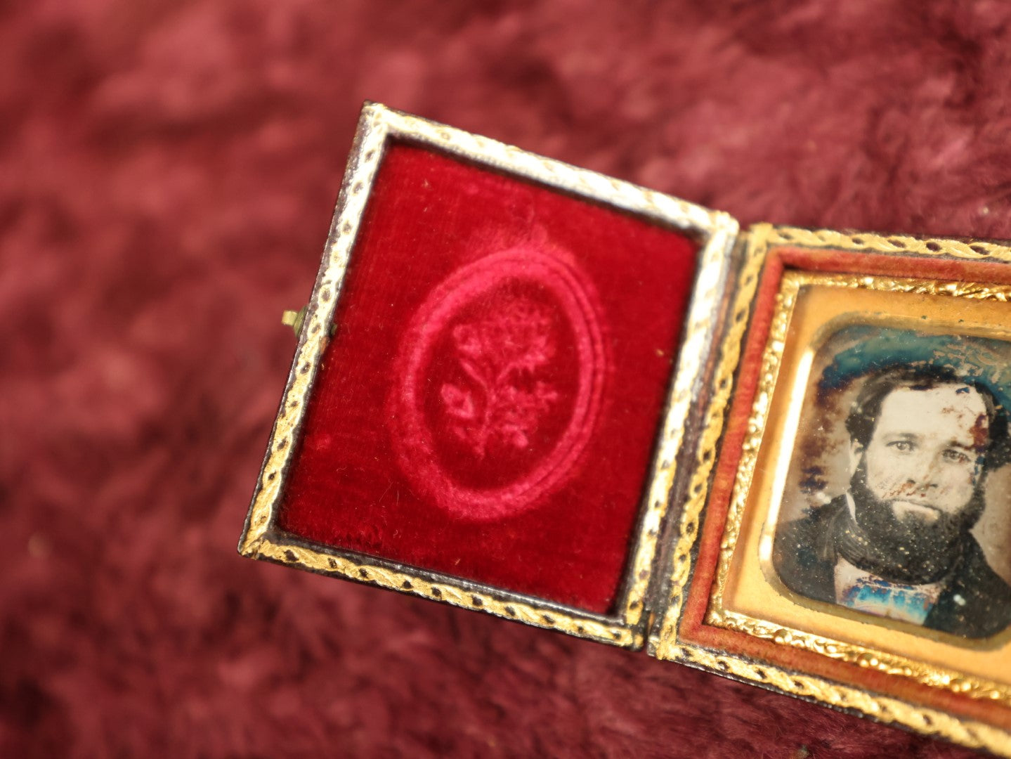 Lot 035 - Antique 1/16th Plate Daguerreotype Photograph In Intact Case Of Man With Beard, Flower On Red Pillow, Heavy Wear