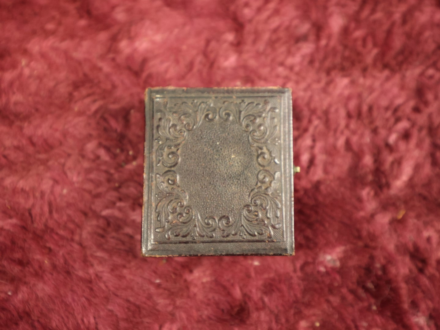 Lot 035 - Antique 1/16th Plate Daguerreotype Photograph In Intact Case Of Man With Beard, Flower On Red Pillow, Heavy Wear
