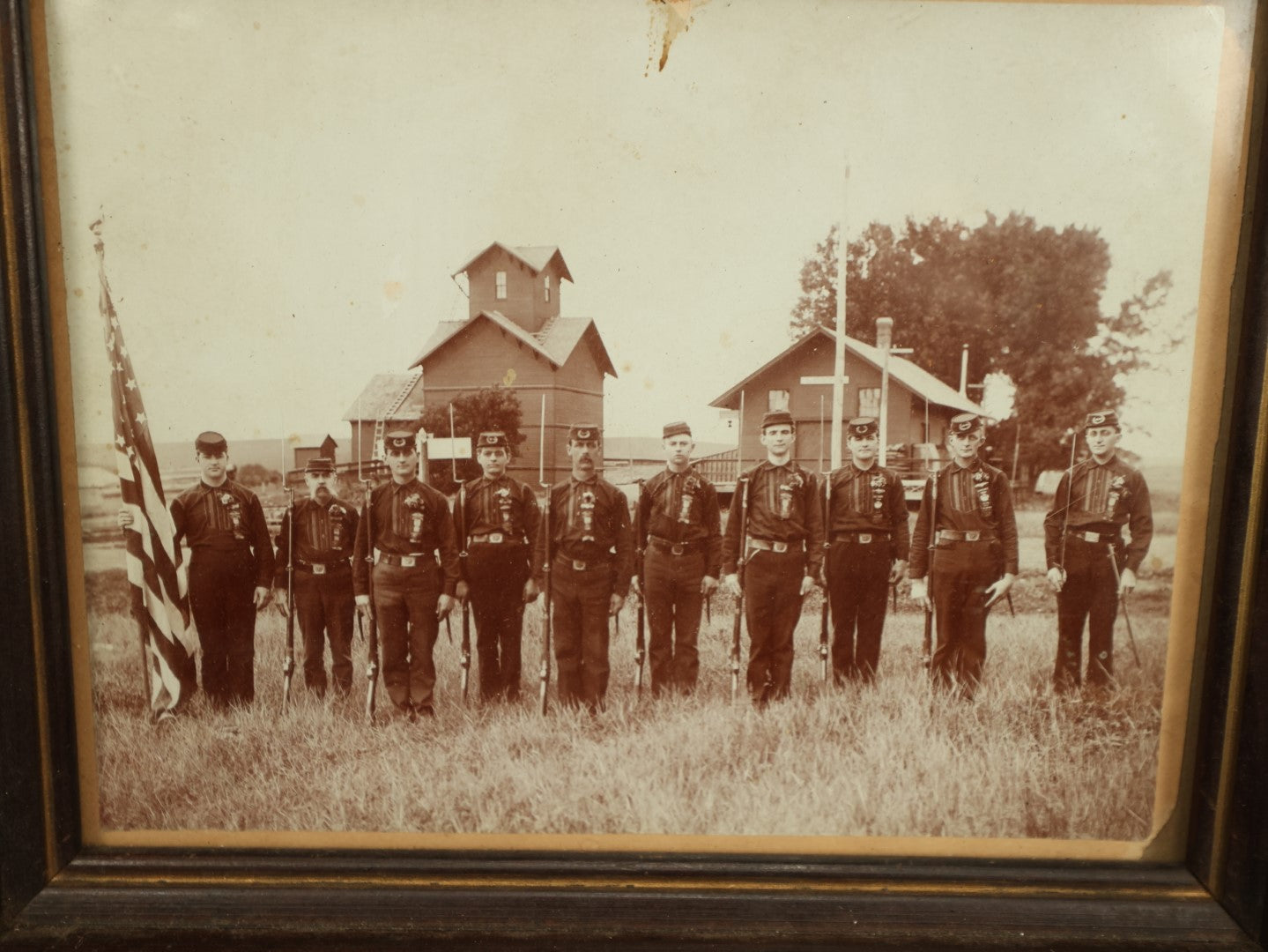 Lot 054 - Antique Framed Boarded Photo Of Soldiers With Various Ribbons, Flag, Etc., Possibly Nebraska Volunteers Or Militia, As Written On Back Of Frame