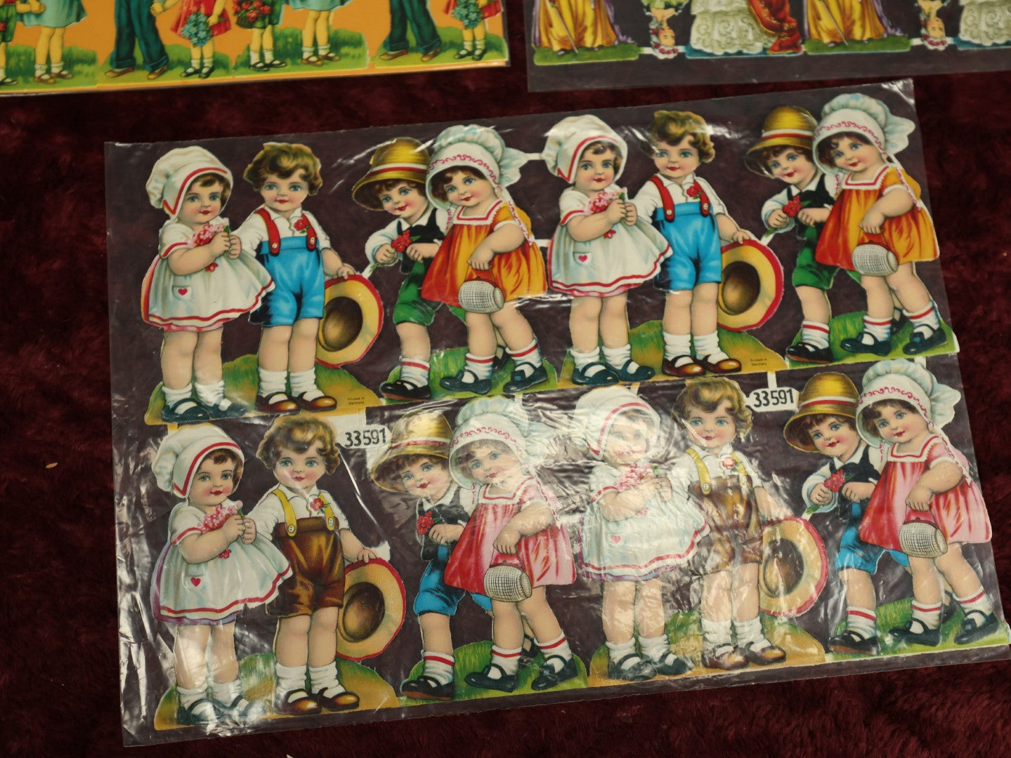 Lot 060 - Grouping Of Three Uncut Die Cut Scrapbooking Paper Sheets, Two Depicting Children, One Of Elegantly Dressed Women, Printed In Germany
