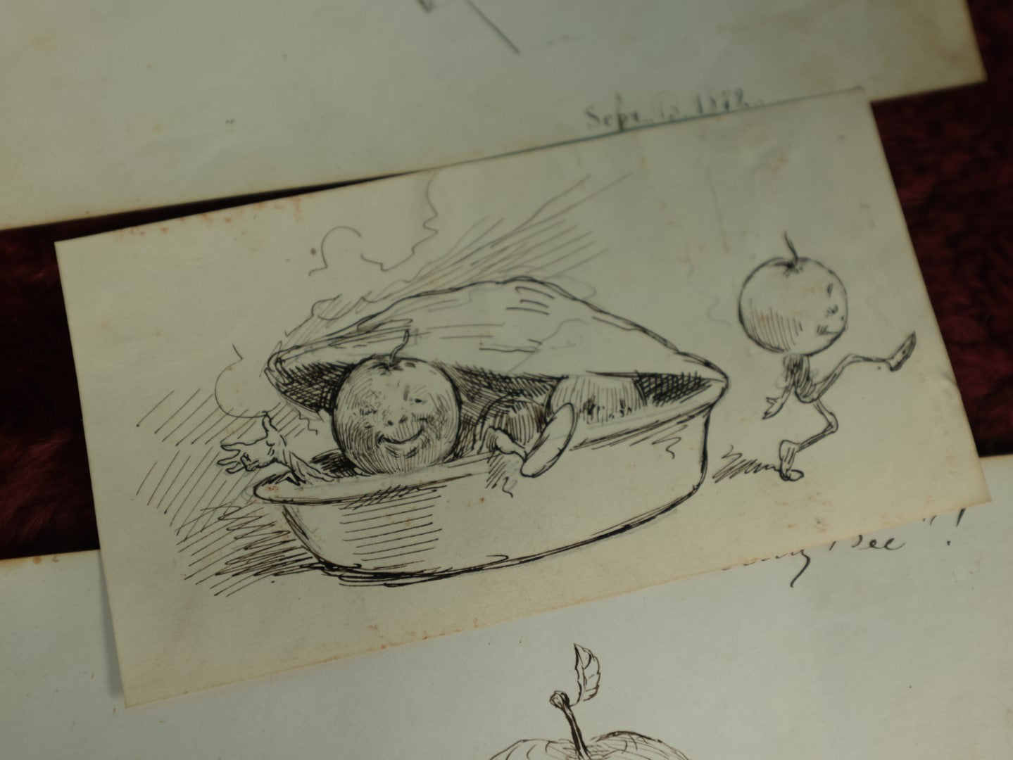 Lot 071 - Grouping Of Three Original Pen And Ink Sketches, 1972 Depiction Of The American Flag From Ashland, New Hampshire, Anthropomorphic Apples Leaving Apple Pie, And Other Apple Related One, Dated 1879