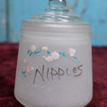 Lot 091 - Antique Hazel Atlas Frosted Glass Hand Painted "Nipples" Jar, Likely Used For Holding Baby Bottle Nipples, With Lid, Note Losses To Paint