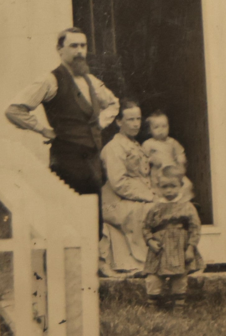 Lot 012 - Large Plate Exterior Tintype Of A Family Outside Of Their Home, Two Adults And Three Children, With White Picket Fence, 6-7/8" X 4-7/8"