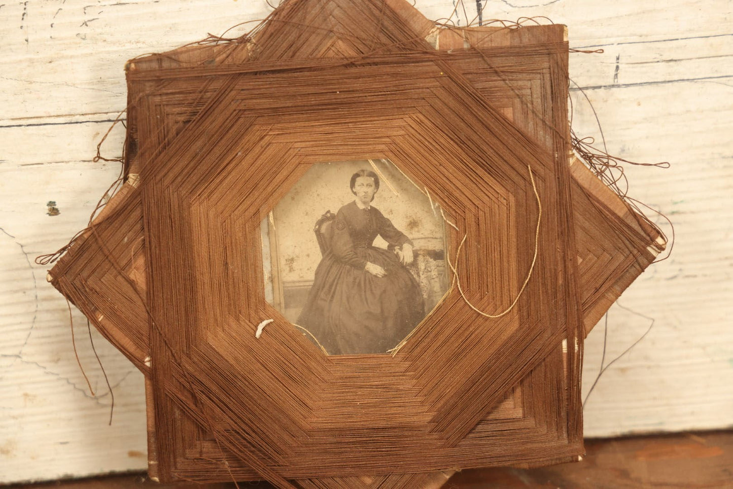 Lot 022 - Antique String Folk Art Frame With C.D.V. Photograph Of A Young Woman Seated In A Chair, Note Some String Unwound