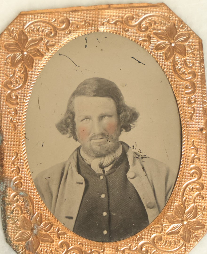 Lot 044 - Antique 1/9th Plate Tintype In Brass Mat Of A Middle Aged Bearded Man With Rosy Tinted Pink Cheeks, Slight Grin