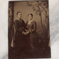 Lot 068 - Single Antique Tintype Photograph Of Two Women Posing Holding Hands, Embracing, With Trees In Back Drop