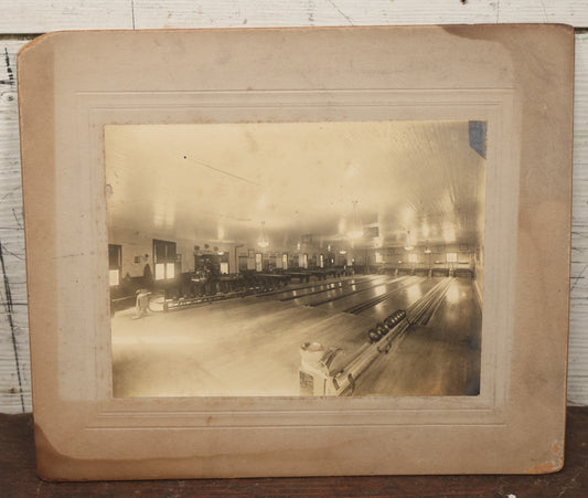 Lot 068 - Antique Boarded Occupational Photograph Of An Old Time Bowling Alley, With Man Behind Counter, Signage