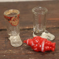 Lot 086 - Three Piece Vintage Christmas Grouping Including Two Glass Santa Boots And A Hard Red Plastic Santa Claus Light Bulb