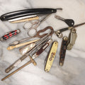 Lot 143 - Junk Drawer Grouping, 10+ Pieces Of Miscellaneous Tools, Including Pocket Knives, Straight Razor, Button Hooks, Whistle, Scissors, Etc
