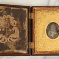 Lot 098 - Antique 1/6th Plate Daguerreotype Photograph Of A Young Baby In A Thermoplastic Case With Deep Brass Mat, Note Heavy Wear, Degradation To Photo, But Baby's Face Still Visible
