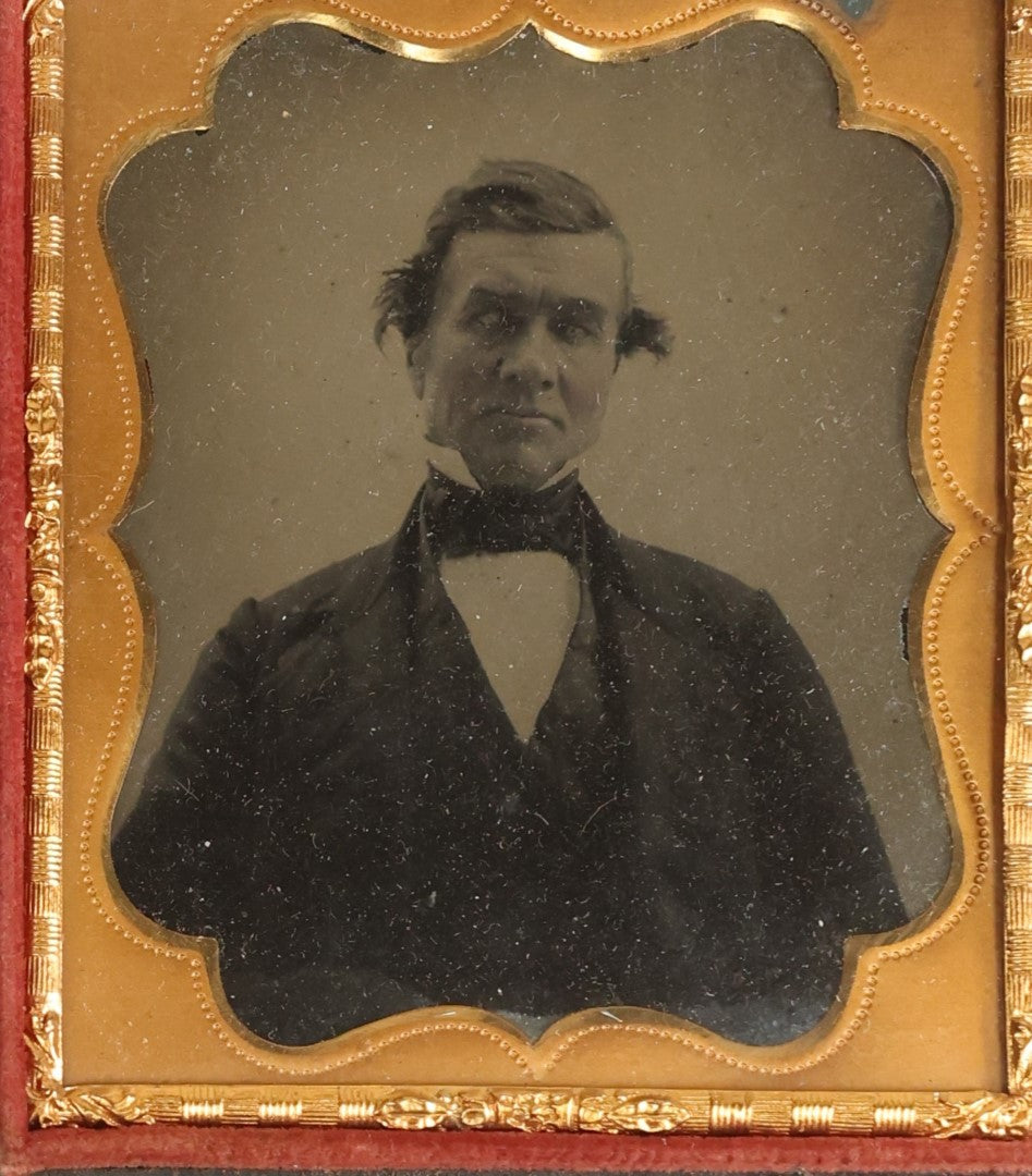 Lot 105 - Antique 1/6th Plate Ambrotype Of An Older Man With Odd Looking Eyes, Likely Blue Eyes, In Split Complete Patriotic Letherette Union Case, With Eagle Holding Shield, Flags