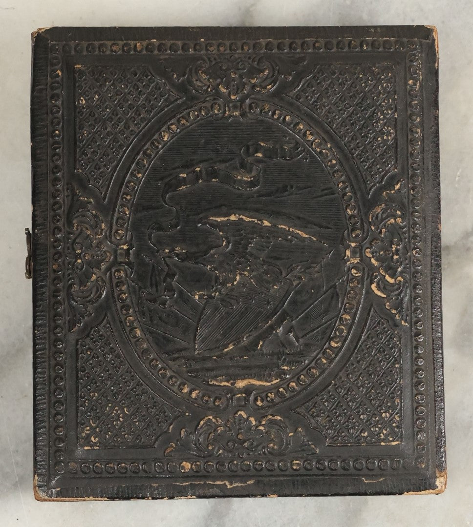 Lot 105 - Antique 1/6th Plate Ambrotype Of An Older Man With Odd Looking Eyes, Likely Blue Eyes, In Split Complete Patriotic Letherette Union Case, With Eagle Holding Shield, Flags