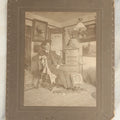 Lot 120 - Antique Boarded Photo Of A Young Man College Student, Likely In A Dorm Room, With Interior Scene Including Artwork, Early Light Fixture, Dresser, Pennant, Fur Rug, And More