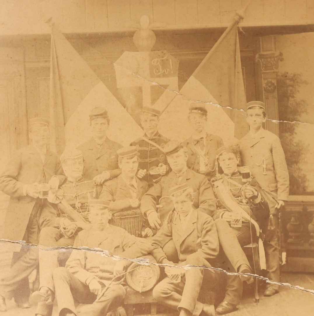 Lot 126 - Antique Boarded Group Photo, Very Poor Condition, Many Losses And Breaks, Of A German Fraternal Or Military Organization, With Many Flags And Regalia, Men Holding Mugs Of Beer (Note Man From Lot 123, Left Side Middle Row)