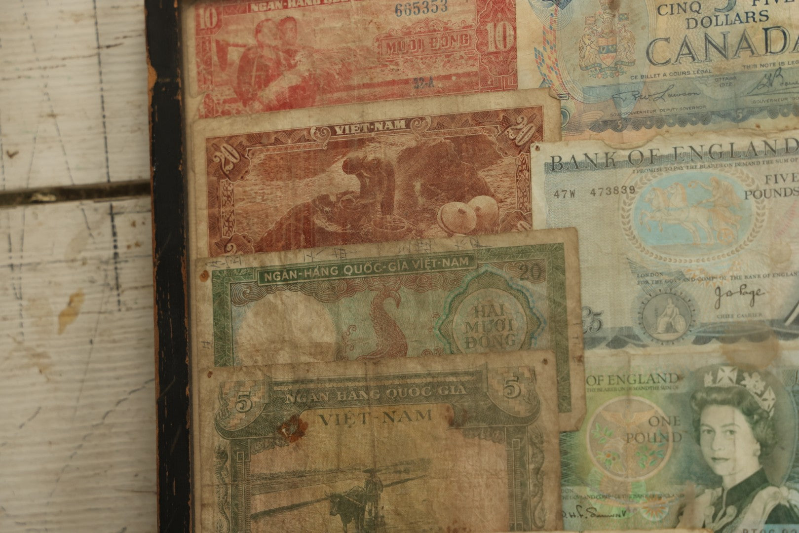 Lot 043 - Vintage Pencil Sketch Folk Art Of Man Weaving Hat With Nine Pieces Of Foreign Currency In Frame From Canada, Vietnam, Etc., Artist Signed And Dated, Illegible