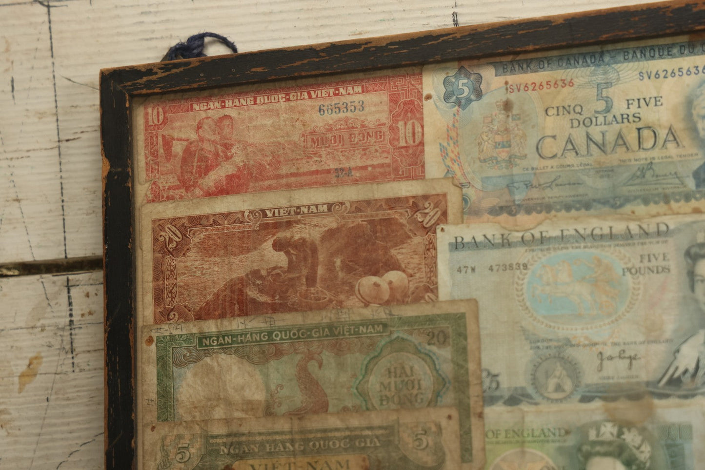 Lot 043 - Vintage Pencil Sketch Folk Art Of Man Weaving Hat With Nine Pieces Of Foreign Currency In Frame From Canada, Vietnam, Etc., Artist Signed And Dated, Illegible