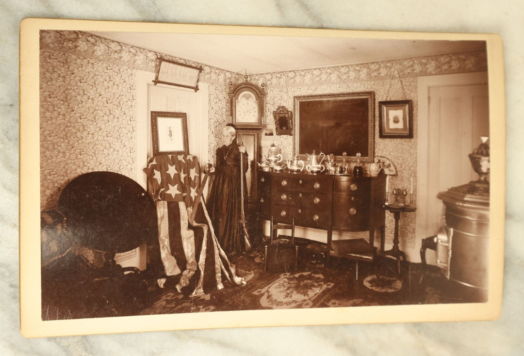 Lot 070 - Pair Of Large Size Antique Cabinet Card Photographs Of An Elderly Woman Posing With A Large Hand Sewn American Flag, Rifle, Possible American Revolution Connection Or Centennial, Chamberlain, Photographer, Rhode Island And Massachusetts