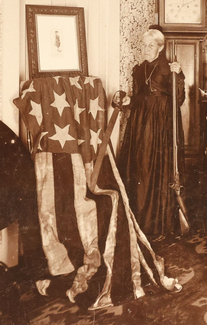 Lot 070 - Pair Of Large Size Antique Cabinet Card Photographs Of An Elderly Woman Posing With A Large Hand Sewn American Flag, Rifle, Possible American Revolution Connection Or Centennial, Chamberlain, Photographer, Rhode Island And Massachusetts