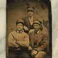 Lot 097 - Single Antique Tintype Photograph Of A Group Of Three Cheeky Young Men In Caps, Smirking