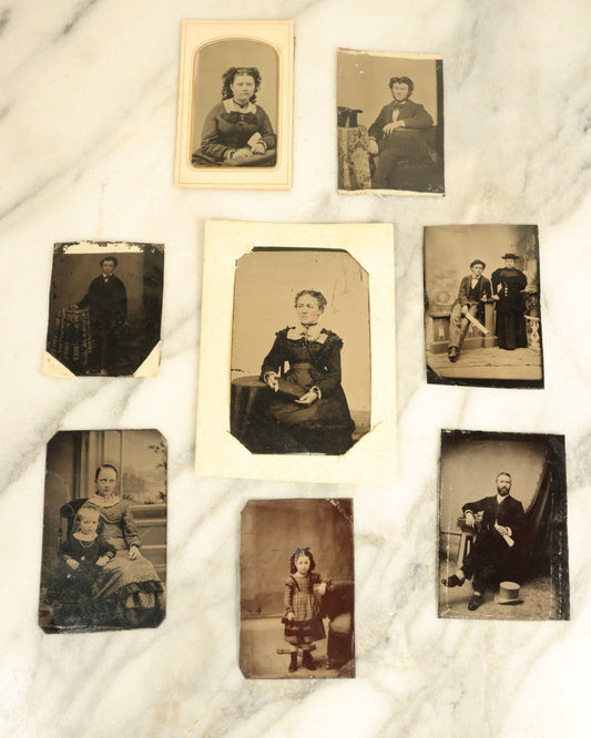 Lot 101 - Grouping Of Eight Assorted Antique Tintype Photographs Of Men, Women, And Children, Including Little Girl With Hand Tinted Blue Bow, Little Girl Holding Doll