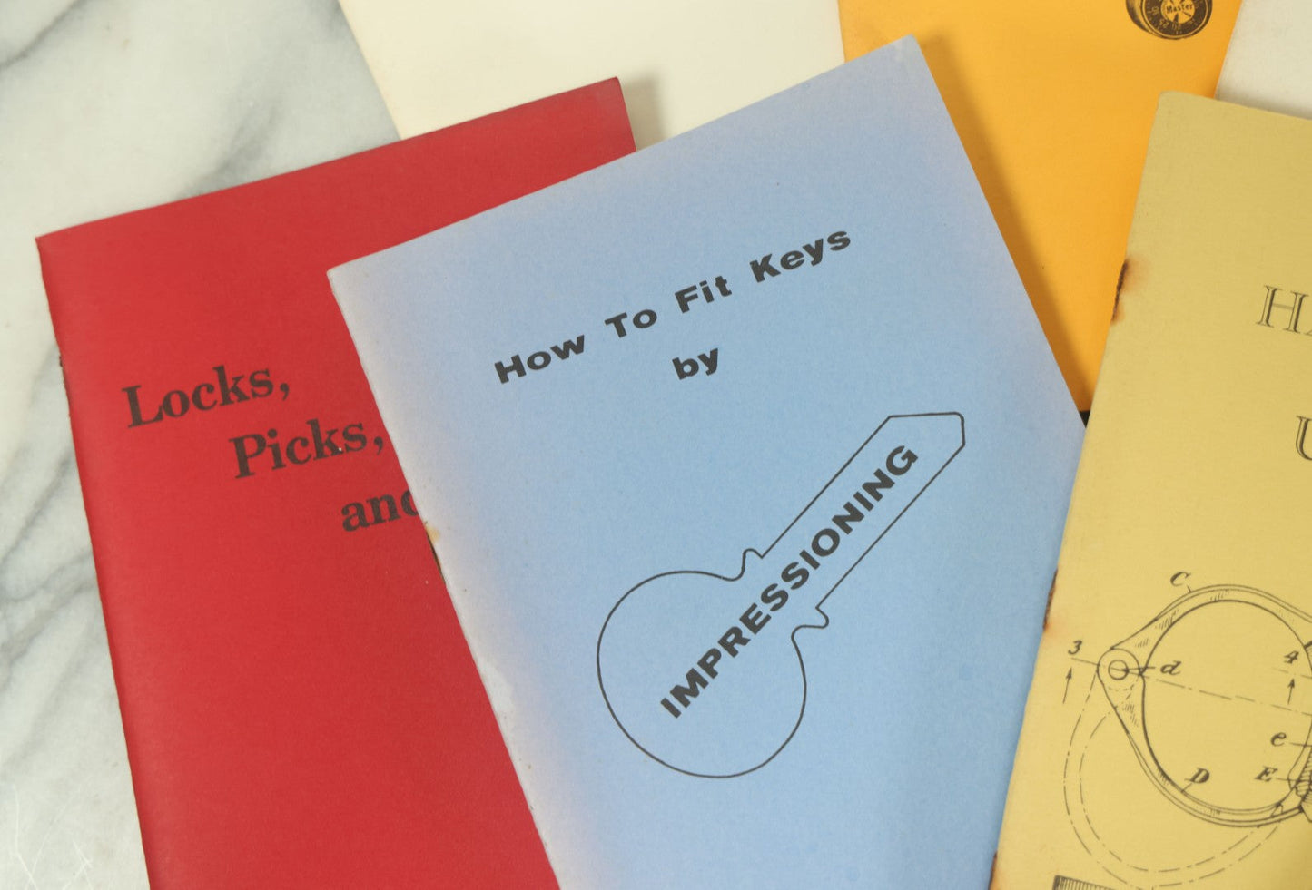 Lot 094 - Grouping Of Seven Booklets On Handcuffs And Locksmithing, Including How To Open Handcuffs Without Keys, Lock Picking, Etc., By Desert Publications, Late 1970s