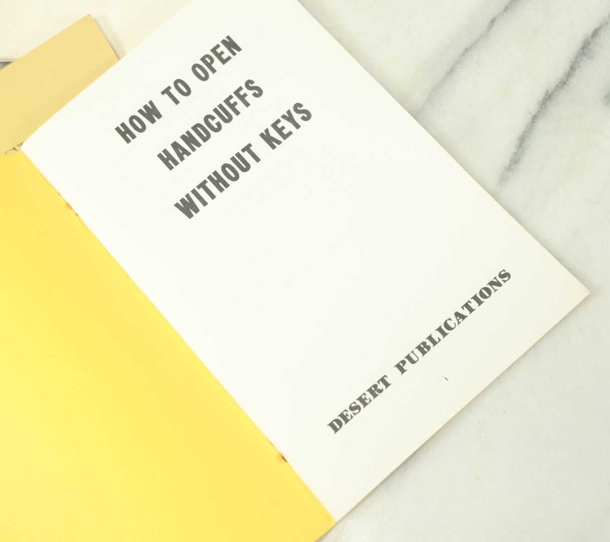 Lot 094 - Grouping Of Seven Booklets On Handcuffs And Locksmithing, Including How To Open Handcuffs Without Keys, Lock Picking, Etc., By Desert Publications, Late 1970s