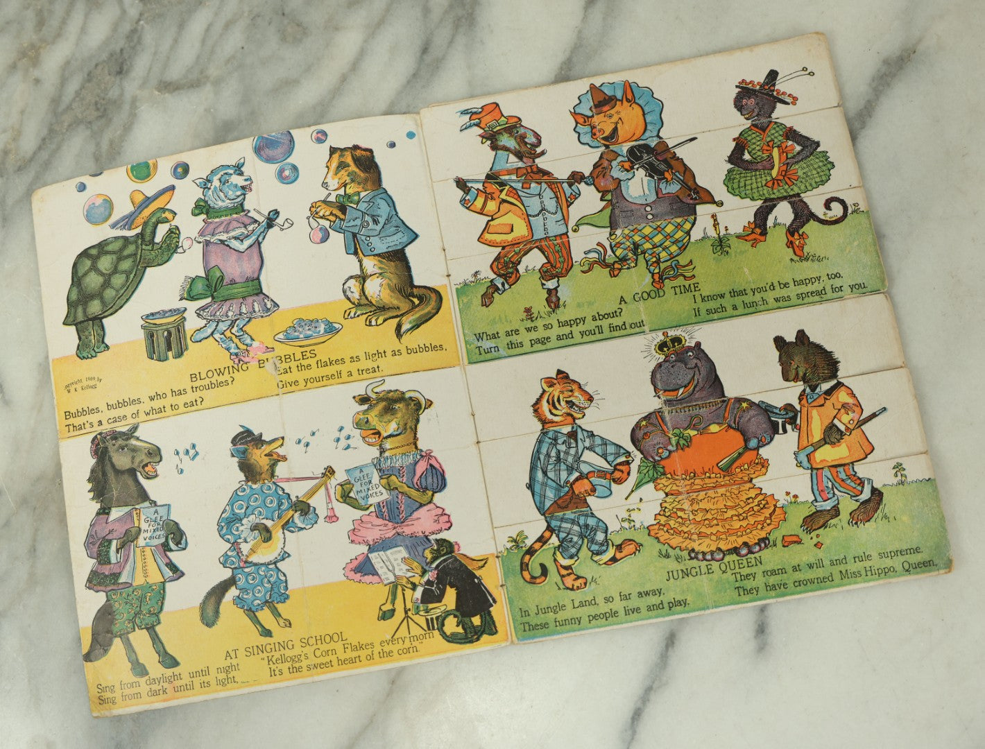 Lot 097 - Antique Kellogg's Cereal Advertising Book, "Funny Jungleland Moving Pictures" With Anthropomorphic Animals, Pages Flip To Mix And Match Heads, Outfits, Bodies, Copyright 1909 By W.K. Kellogg, Battle Creek, Michigan