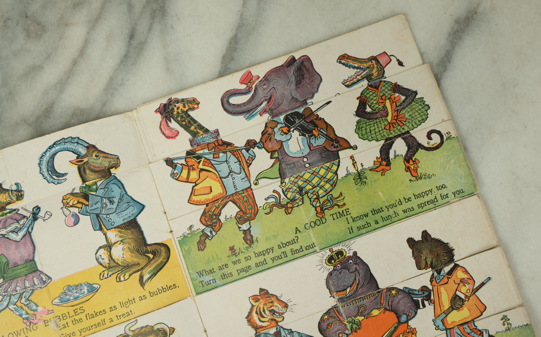 Lot 097 - Antique Kellogg's Cereal Advertising Book, "Funny Jungleland Moving Pictures" With Anthropomorphic Animals, Pages Flip To Mix And Match Heads, Outfits, Bodies, Copyright 1909 By W.K. Kellogg, Battle Creek, Michigan