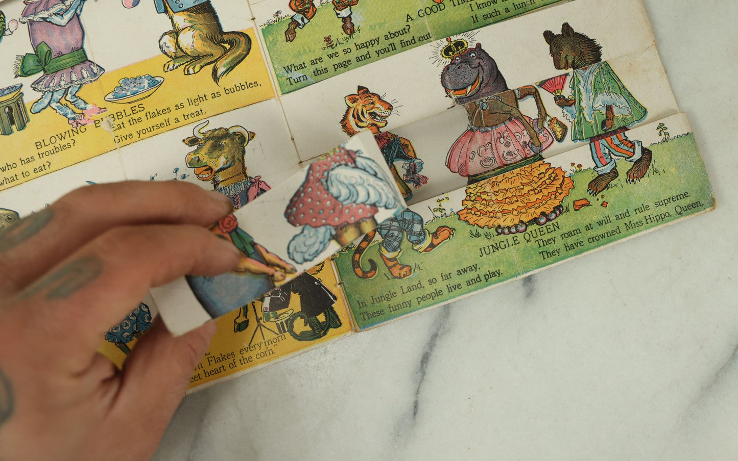 Lot 097 - Antique Kellogg's Cereal Advertising Book, "Funny Jungleland Moving Pictures" With Anthropomorphic Animals, Pages Flip To Mix And Match Heads, Outfits, Bodies, Copyright 1909 By W.K. Kellogg, Battle Creek, Michigan