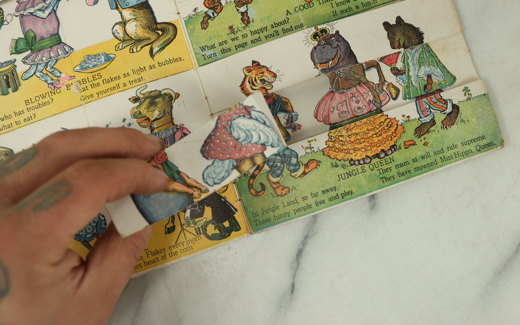Lot 097 - Antique Kellogg's Cereal Advertising Book, "Funny Jungleland Moving Pictures" With Anthropomorphic Animals, Pages Flip To Mix And Match Heads, Outfits, Bodies, Copyright 1909 By W.K. Kellogg, Battle Creek, Michigan