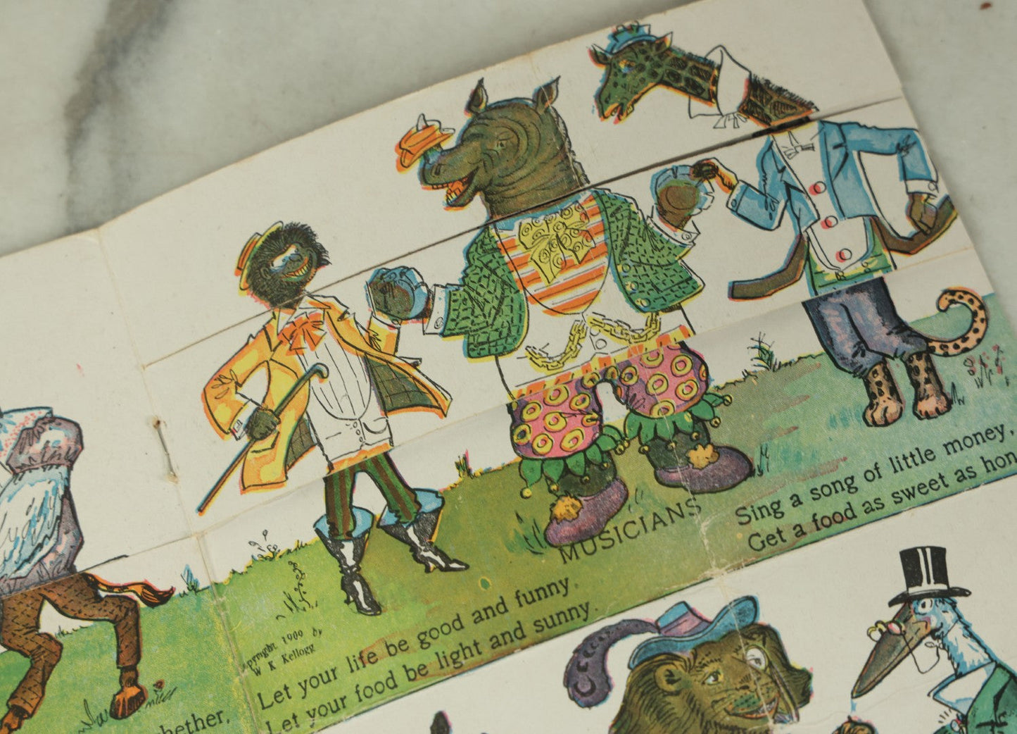 Lot 097 - Antique Kellogg's Cereal Advertising Book, "Funny Jungleland Moving Pictures" With Anthropomorphic Animals, Pages Flip To Mix And Match Heads, Outfits, Bodies, Copyright 1909 By W.K. Kellogg, Battle Creek, Michigan