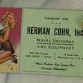 Lot 109 - Three Piece Ephemera Grouping Including Pinup Blotter For Herman Cohn, Inc Naval Uniforms, Vogue Cigarette Papers, And Joan Bennett Movie Star Card