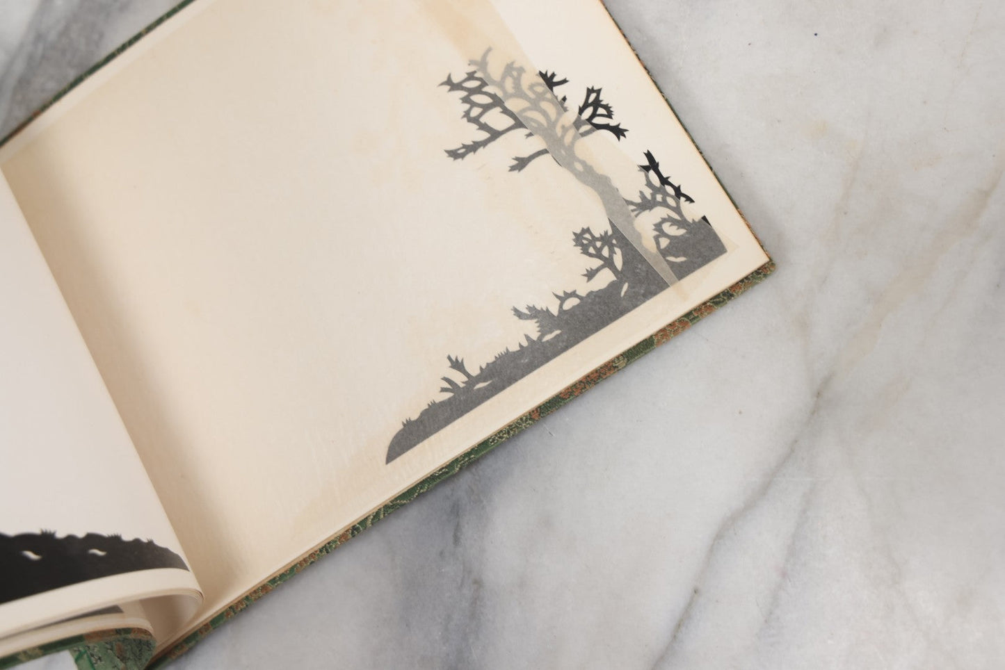 Lot 120 - Vintage East Asian Cloth Covered Art Book With Black Paper Cut Silhouettes