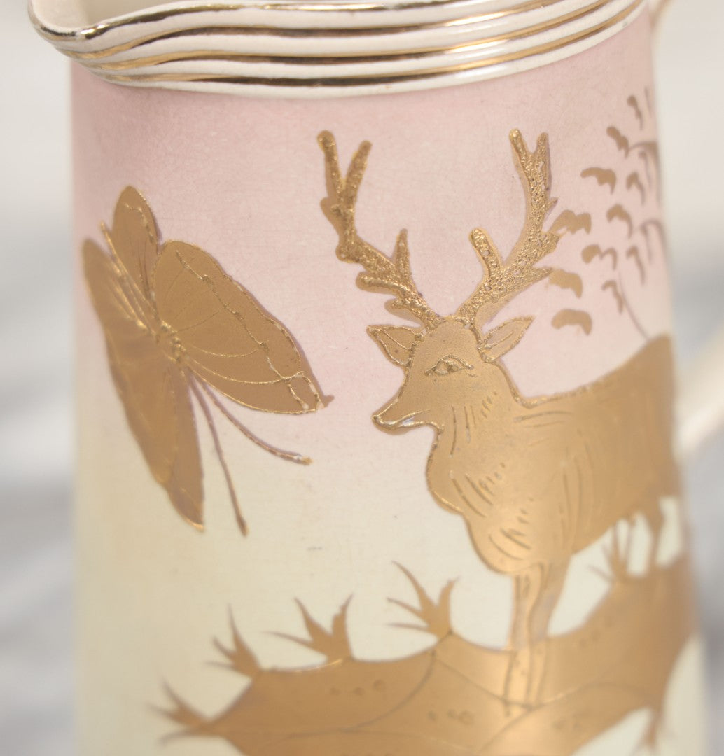 Lot 032 - Antique Ceramic Pitcher With Butterfly, Elk Motif, Pink And Gold Coloring, Minor Chipping
