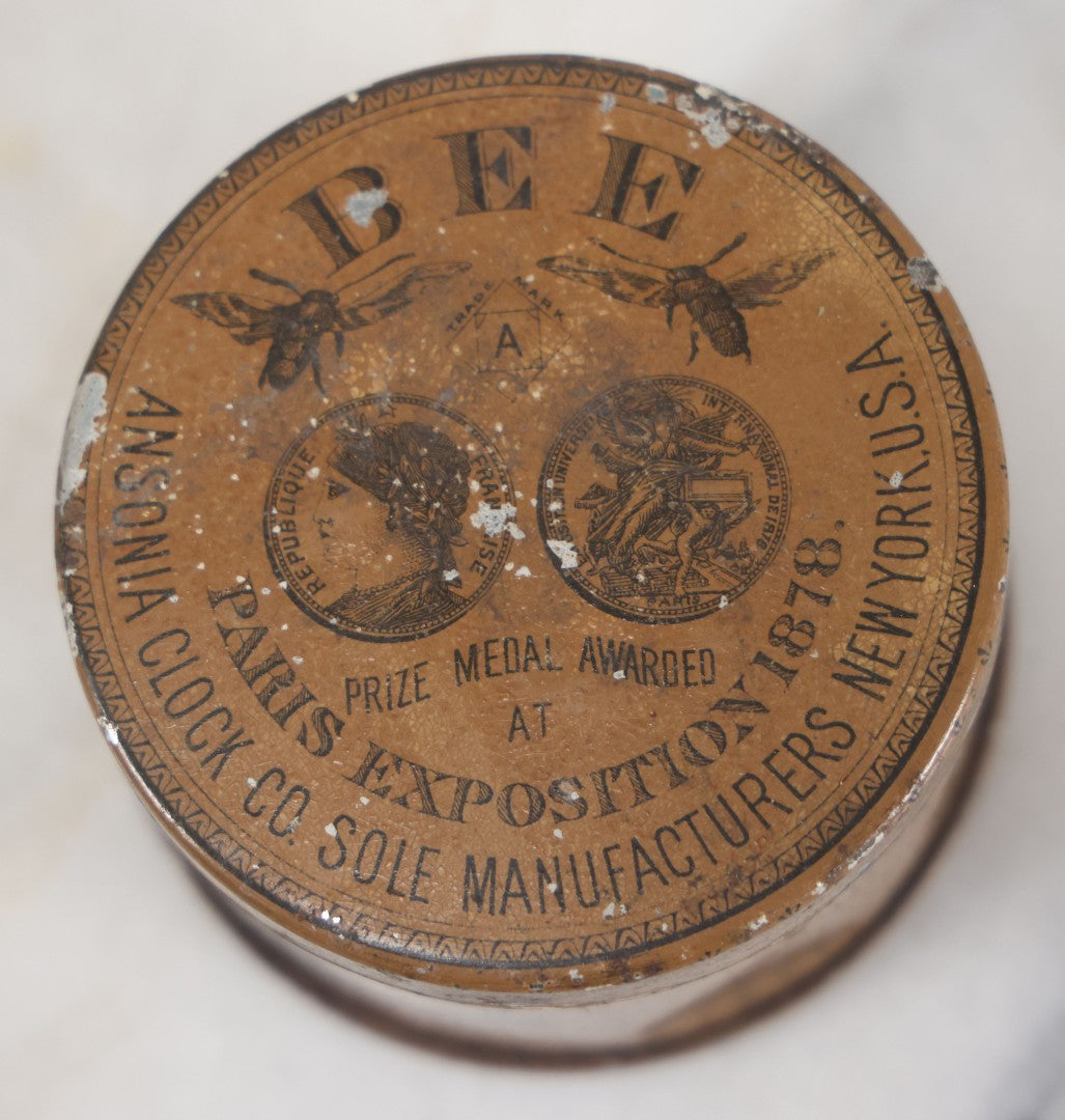 Lot 033 - Antique Advertising Tin For The One Day Bee Clock By Ansonia Clock Company, With Bee Graphics, Brooklyn, New York, Note Various Losses