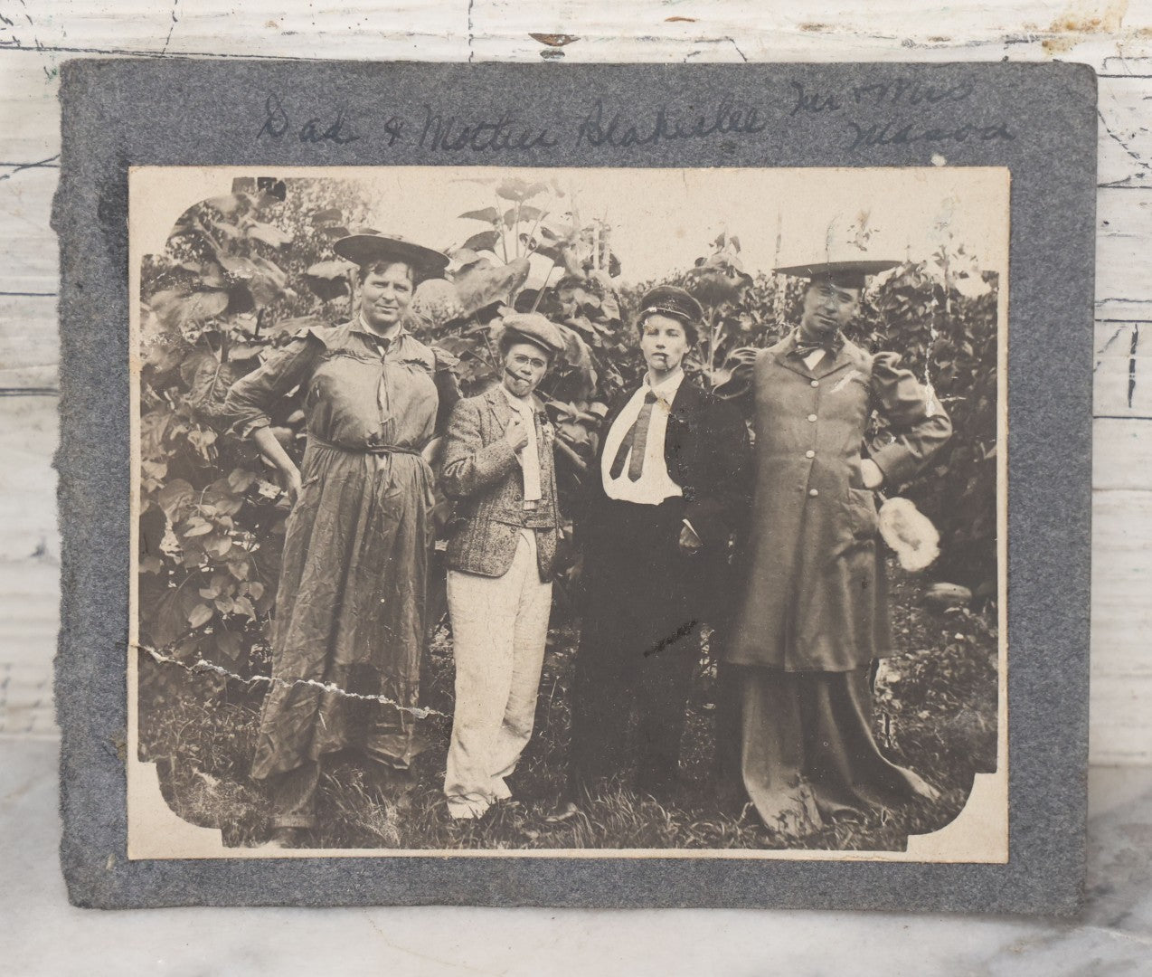 Lot 104 - Antique Snapshot Photo On Album Paper Of Two Couples Cross Dressing, Men In Dresses, Women Smoking Cigars, Identified
