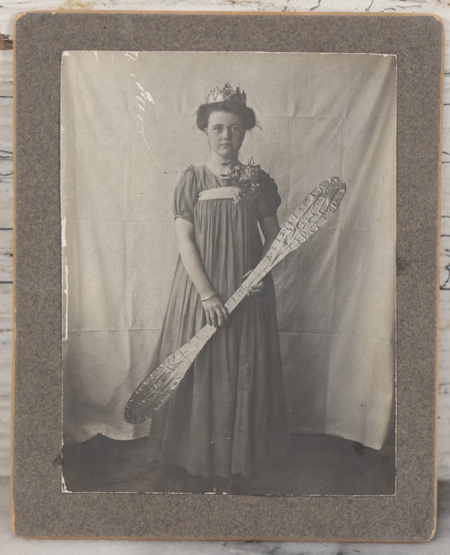 Lot 108 - Antique Boarded Photo Of A Young Woman In A Crown Holding A Silvery Foil Covered Paddle, Unknown Occasion