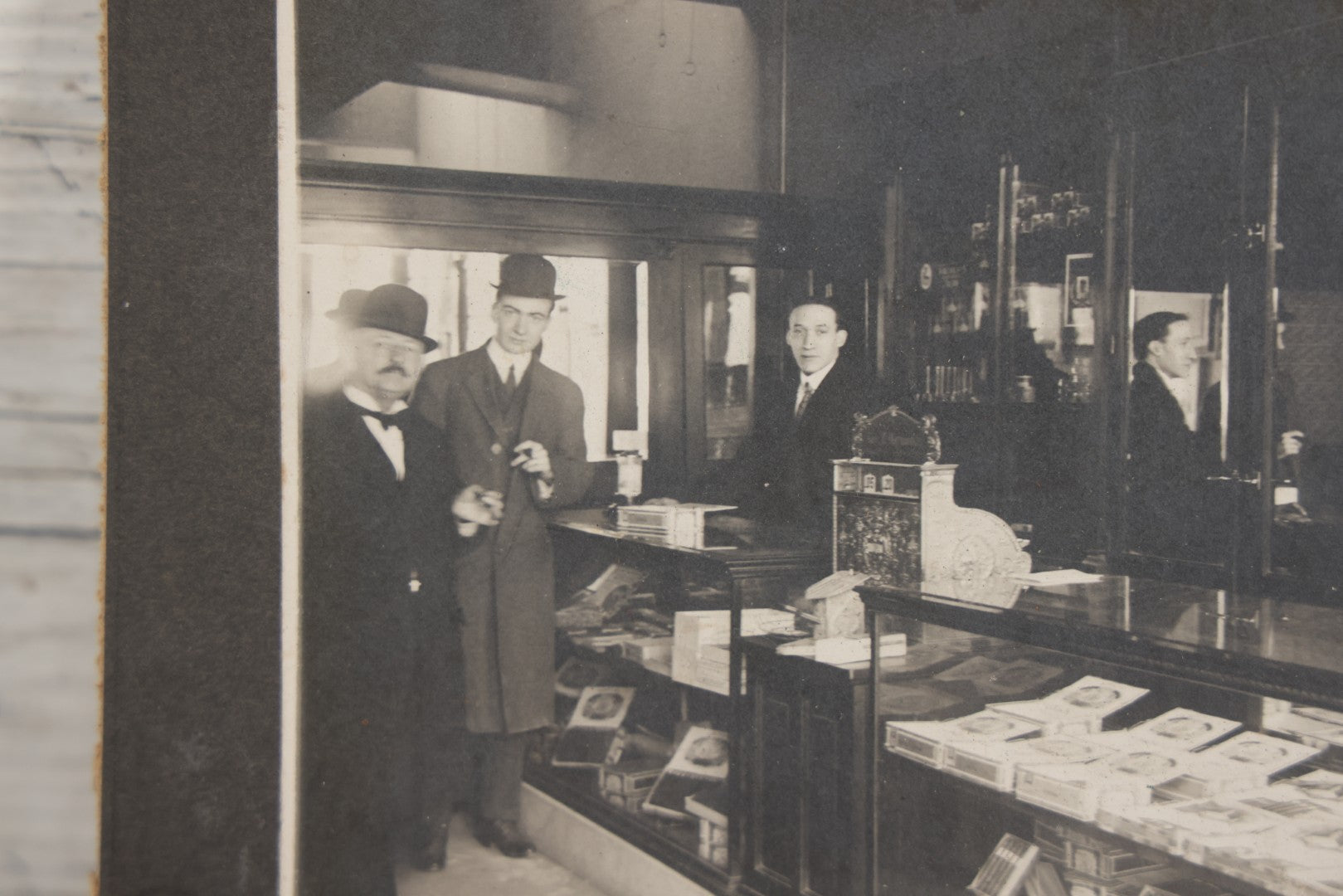 Lot 109 - Antique Boarded Photo Of A Tobacco, Cigar Shop, With Man Behind Counter, Customers In Bowler Hats, Various Cigar Brands